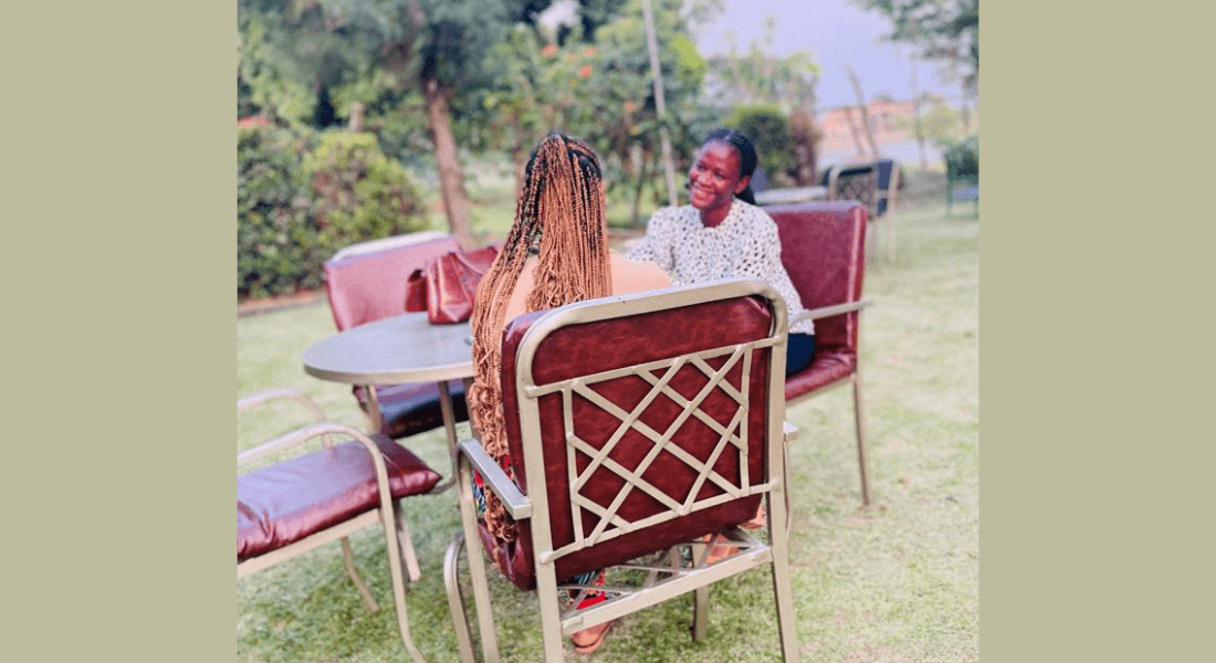 Interview between two women sitting on a table