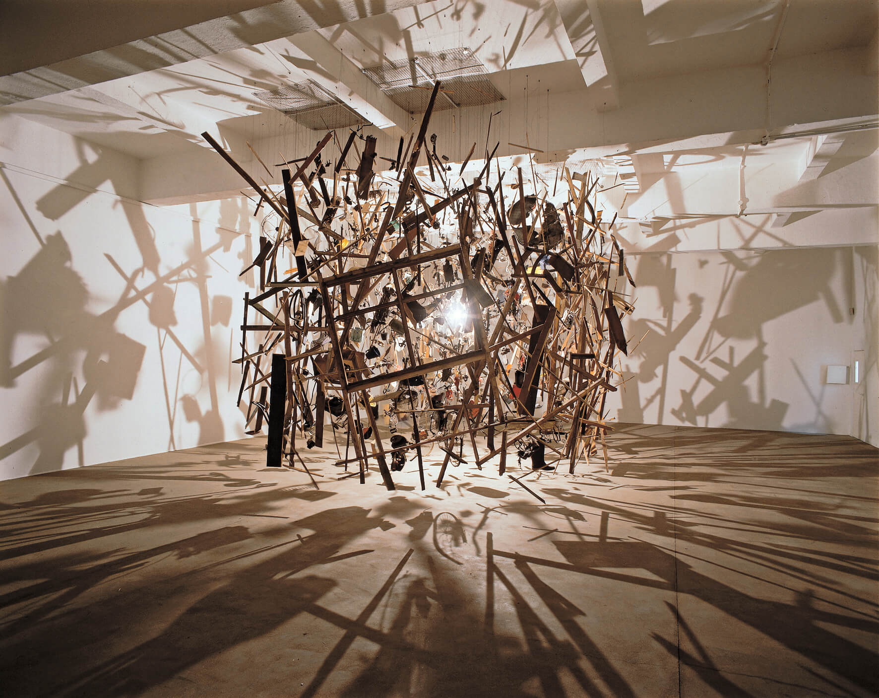 Cornelia Parker, Cold Dark Matter: An Exploded View, (1991). Installation view, Chisenhale Gallery, 1991. Comissioned and produced by Chisenhale Gallery London. Tate Collection, London. Photo Copyright Hugo Glendinning. Courtesy the artist and Frith Street Gallery, London.