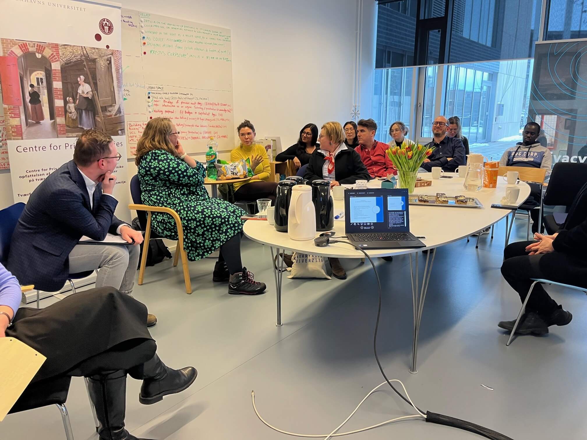 A group of researchers sitting around a table discussing
